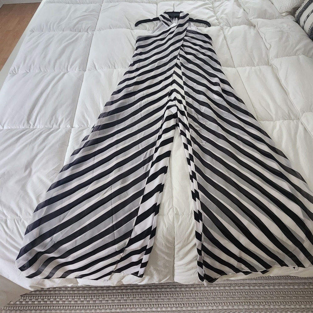 Stunning black and white jumpsuit with chiffon dress overlay, halter neck.